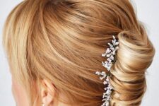 33 a twisted chignon with fresh blooms, a messy and voluminous bump on top, side bangs is a stylish idea for a mother of the bride
