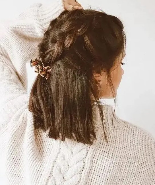 a creative dark brown half up wedding hairstyle with large braids on top and hair down is a cool idea for a boho bride or bridesmaid