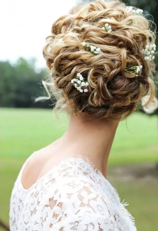 raise your curly hair into a comfy and chic updo and add some fresh blooms