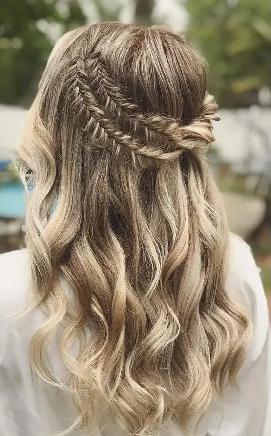 a boho half updo with a double fishtail braid halo and waves down is a dreamy and beautiful idea