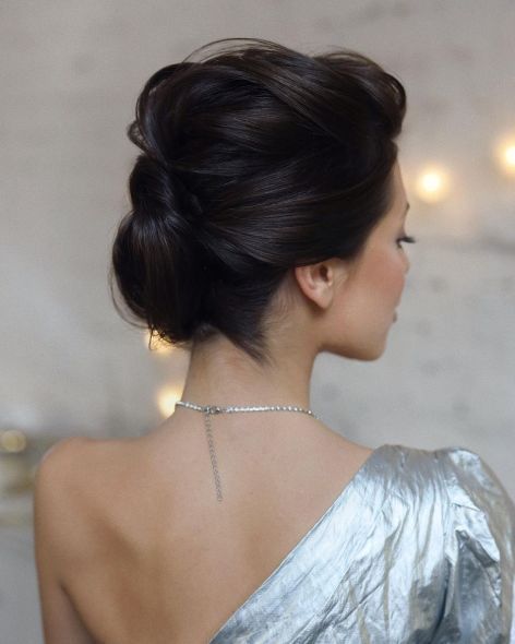 a chic mother of the bride updo with a bump on top and several volumes twisted is a beautiful and comfy to wear hairstyle