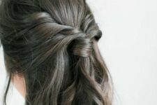 40 a boho half updo with a sleek top, a twisted ponytail and waves down is a lovely solution