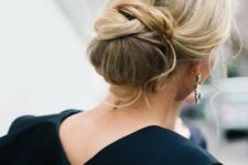 40 a creative low chignon hairstyle with some twists and curled bangs for a chic look