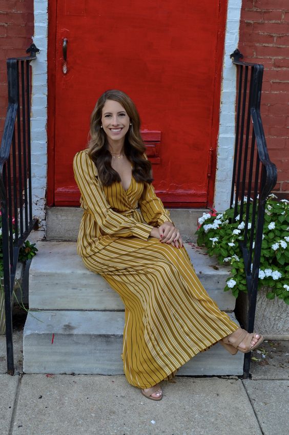 a yellow striped maxi dress with a V-neckline, nude shoes and layered necklaces are a lovely combo for a wedding