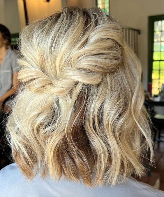 a half updo with a bump on top, a twisted halo and waves down is good for many bridesmaid outfits