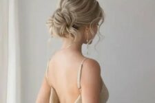 42 a messy and chic low updo with a bump on top and some waves down is an elegant and beautiful hairstyle