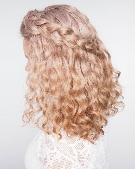 a blonde curly half updo with a single braid placed over the whole head is a lovely idea for a wedding