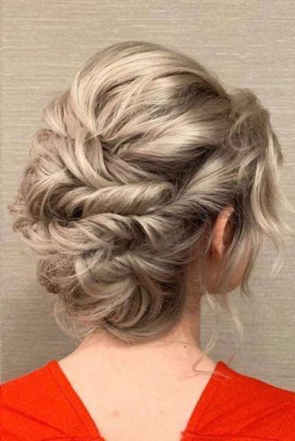 A messy twisted updo with a volume on top, waves and face framing locks is a lovely idea for long hair