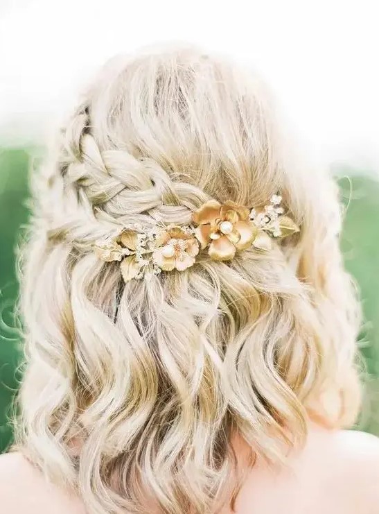 a lovely blonde half updo with a volume on top, a double side braid, a hairpiece and waves down is chic