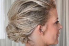 44 a pretty wavy updo with a small low bun with a voluminous and wavy top is a chic idea for a mother of the bride