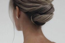 46 a refined twisted updo with a bump on top and a lot of volume, face-framing locks is a stylish idea for a mother of the bride
