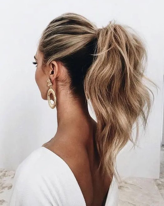 a high ponytail with a bump on top and textural hair is a great ultra-modern idea
