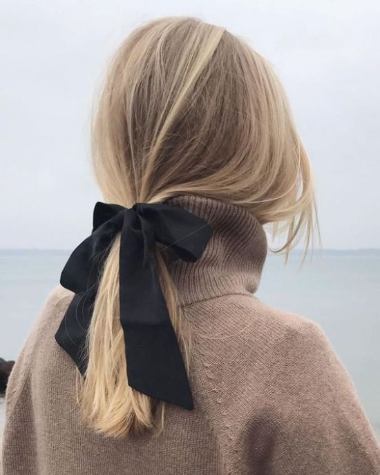 a low ponytail with a black ribbon bow is a cool and chic idea that will fit many formal styles
