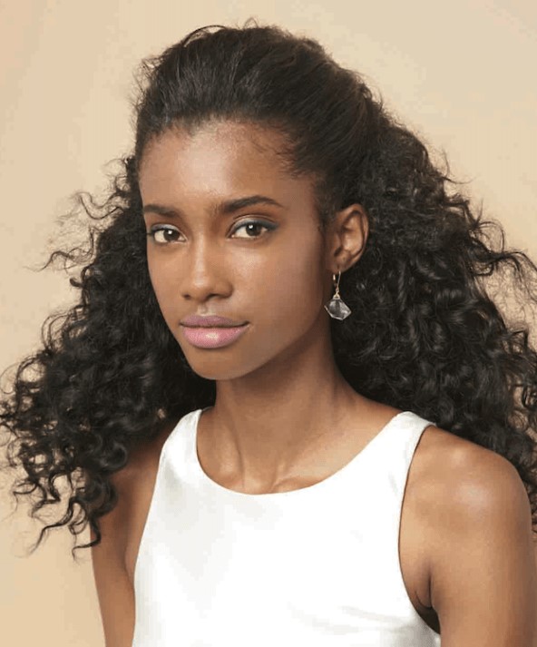 a half updo with a sleek top and lots of curls is a fun and eays to realize solution