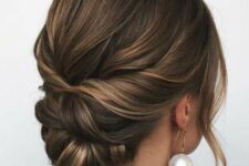 51 a stylish twisted low updo with a volume on top and waves framing the face is an elegant idea for a mother of the bride