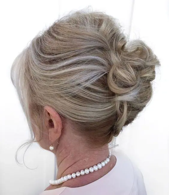 a stylish updo on medium hair, with a bump on top and waves, face-framing locks is a cool idea