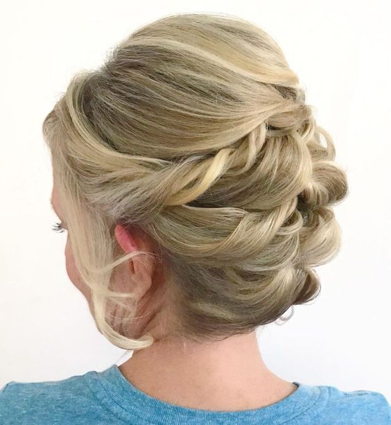 a twisted updo with a bump on top and a lot of volume, with face-framing locks is a cool solution for a mother of the bride