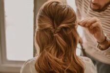 55 a half updo with a bump on top and waves down plus a small ponytail is a quick and cool hairstyle idea for a wedding