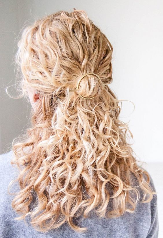 a romantic and easy to make curly half updo with a ring hairpiece and curls down is a chic idea