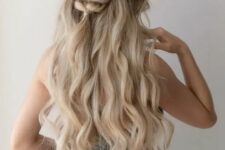 56 a half updo with a wavy top, a braided touch and waves down is a cool idea for a boho bride