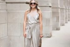 57 a silver jumpsuit with sashes, strappy heels and a leopard print clutch for a bold look