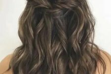 58 a long half updo with a braided halo and waves down is a chic and cool idea for a boho wedding