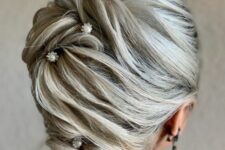 59 an eye-catchy updo with twists and volumes secured with pearl hair pins is a stylish idea for a mother of the bride