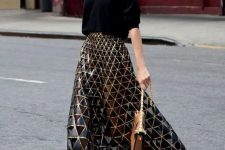 62 a black oversized sweater, a black and gold geometric midi skirt, black lace up shoes and a camel bag