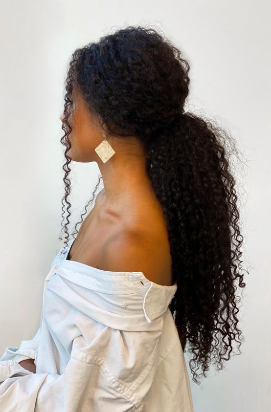 a simple and lovely low ponytail with some curls down to accent the face is a super cool and easy to make idea