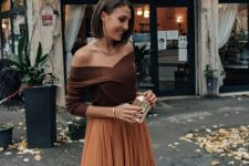 65 an elegant fall wedding guest outfit with a brown off the shoulder top, a rust-colored tulle midi skirt and a small metallic clutch