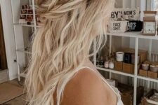 66 a messy boho half updo with a wavy tpo, a braided and twisted halo and waves down is a cool idea for a boho look
