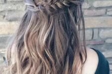 75 a wavy half updo with a thick fishtail braid on one side and twisted hair on the second
