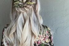 76 a wavy half updo with a volume on top, twisted greenery decorated element and waves down