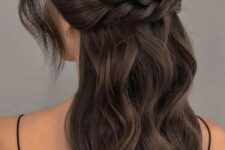 77 a wavy half updo with a wavy bump on top, with a large braided piece that goes horizontally and waves framing the face