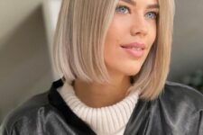 a beautiful blonde blunt midi bob with a soft blonde shade and middle part
