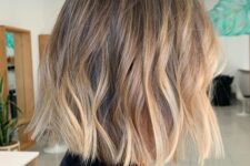 a beautiful bronde blunt bob with waves and a dark root is a stylish and catchy idea, especially with this volume