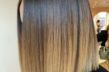 a beautiful cold brunette long bob with an ombre effect with a blonde shade and central part is very sleek and elegant