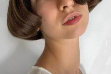 a beautiful ear-length bob with central parting and curved ends is a catchy and lovely idea with a soft touch