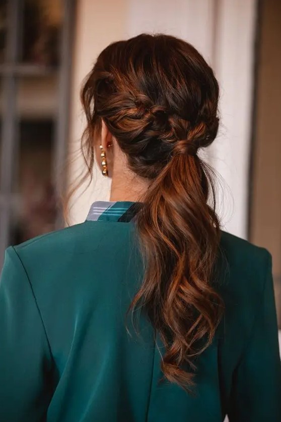 A beautiful low ponytail with a braided halo and some face framing locks is a cool idea for a modern or boho bridesmaid
