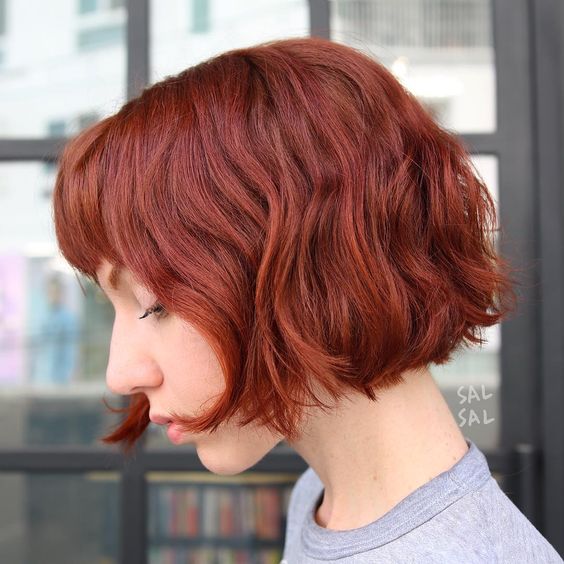 a beautiful wavy jaw line bob with a blunt fringe is a catchy and bright solution, bring dimension to it
