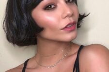 a black ear-length bob with wispy bangs and wavy hair is a catchy and chic idea for a modern look