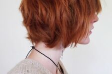 a bold copper red shaggy chin-length bob with a lot of dimension and texture is a super fun idea
