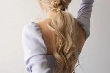 a braided ponytail with waves and face-framing locks is a comfortable to wear hairstyle for a bridesmaid