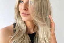 a bright blonde butterfly haircut with curved ends is a lovely idea for a chic and beach-inspired look