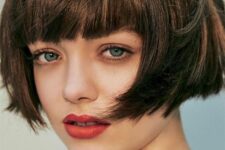 a brunette ear-length bob with a classic fringe and a lot of volume is a stylish French chic idea