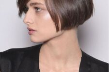 a brunette ear-length bob with side parting, with a sleek finish is a catchy and stylish idea for a modern look