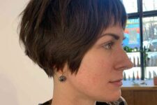 a brunette shaggy ear length bob with a fringe is something between a bob and a pixie and it’s easy to style