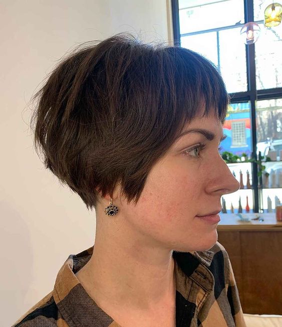 a brunette shaggy ear length bob with a fringe is something between a bob and a pixie and it's easy to style