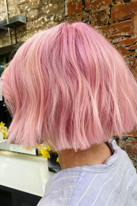 a bubblegum pink midi textural bob with a lot of volume and a bit of waves is a catchy and bright idea