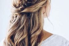 a chic half updo with waves, twists and a fishtail braid going down for a boho bridesmaid